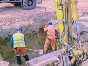 Two construction working doing trenching.